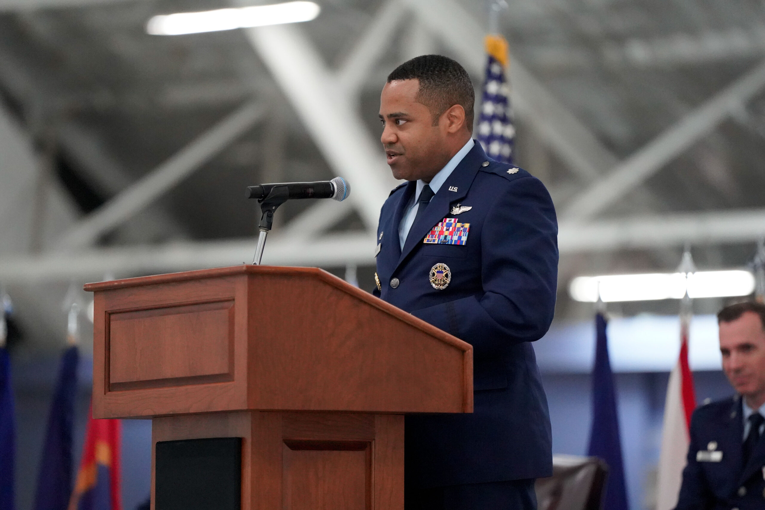 Joseph Van Valen speaking from a podium at a military ceremony